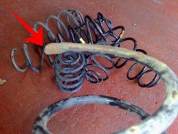 A close up of the jagged broken end of a spring